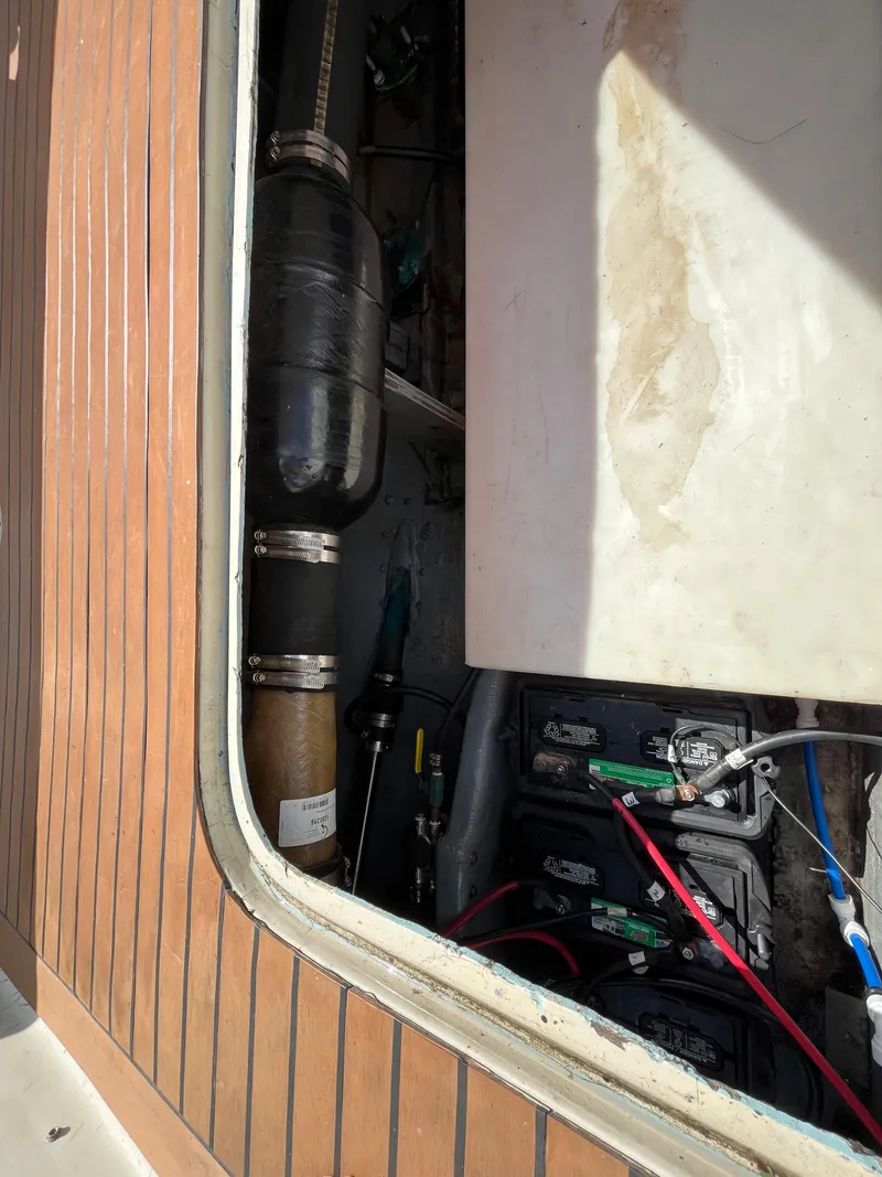 Slide: The Image of Engine compartment of a 1976 Uniflite 28 Salty Dog boat, showing batteries and exhaust system. - 44