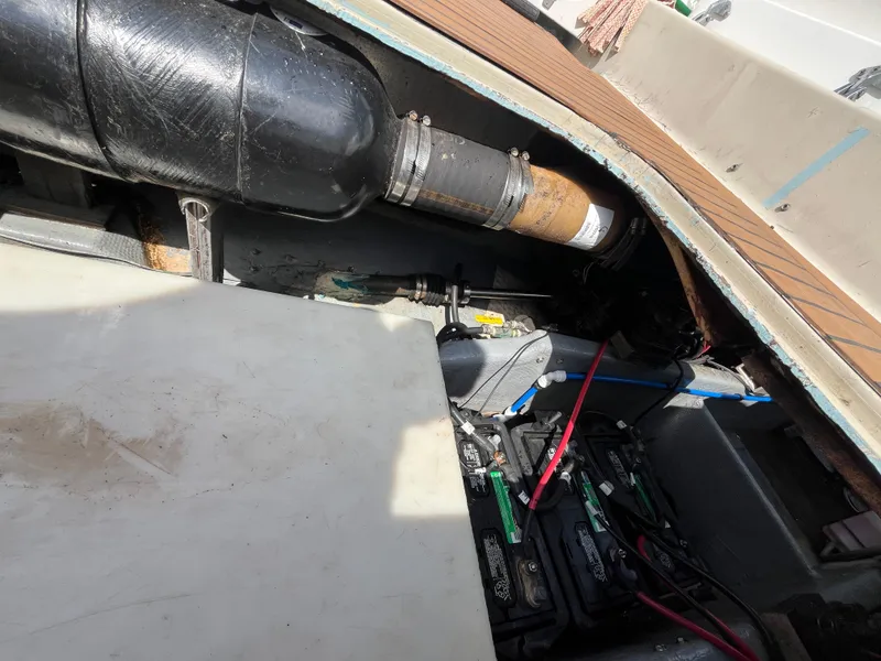 Slide: The Image of Engine compartment of a 1976 Uniflite 28 Salty Dog boat, showing batteries and exhaust system. - 45