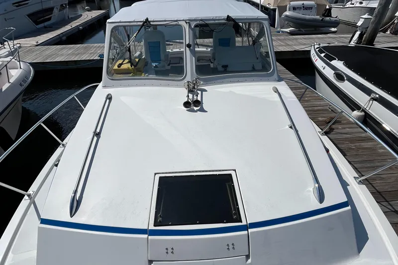 Slide: The Image of 1976 Uniflite 28 Salty Dog boat docked at marina, top view. - 5