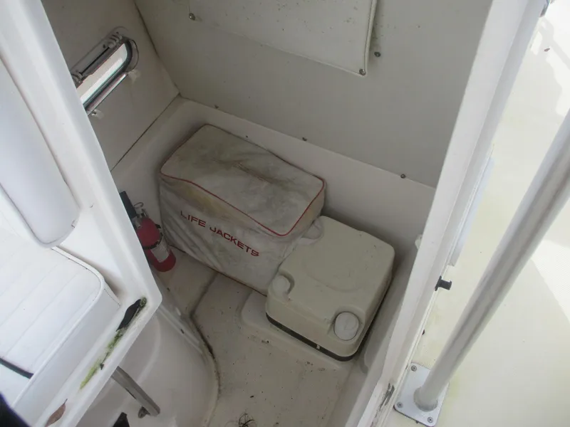 Slide: The Image of Interior of a 2000 Century 2300 Center Console boat with life jackets and a fire extinguisher. - 10