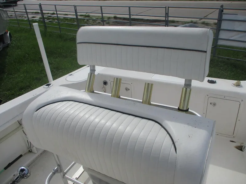 Slide: The Image of Century 2300 Center Console 2000 boat with white seating and rod holders. - 11