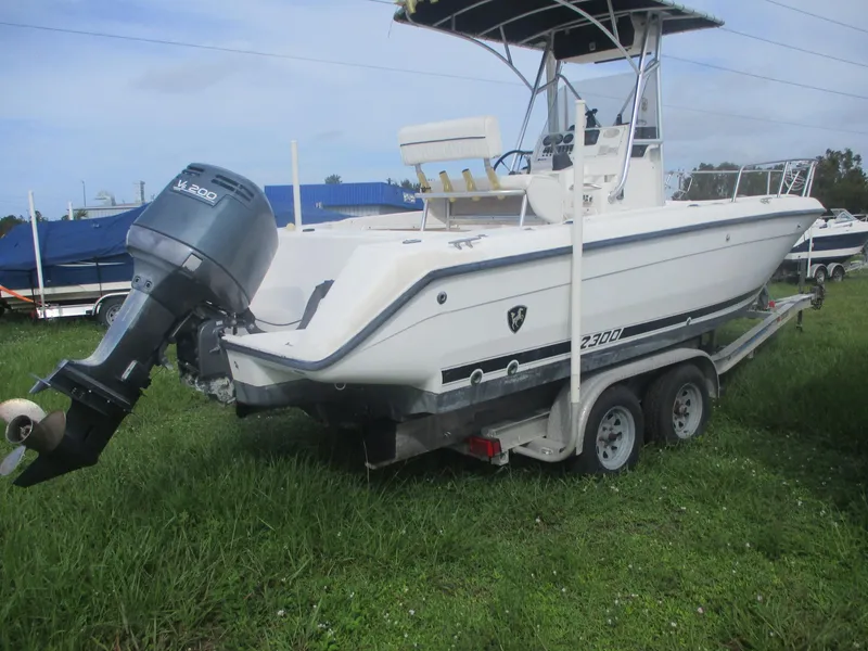 Slide: The Image of Century 2300 Center Console boat, 2000 model, on trailer in grassy area. - 3