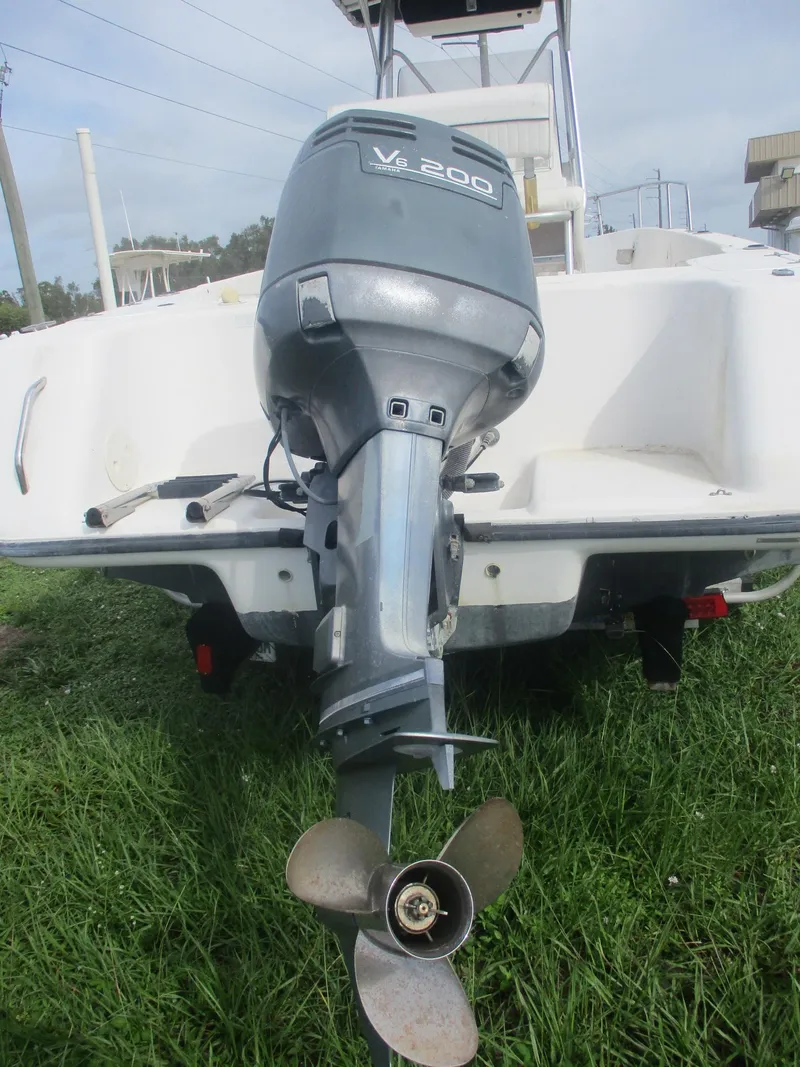 Slide: The Image of Century 2300 Center Console 2000 with V6 200 outboard motor on grass. - 4