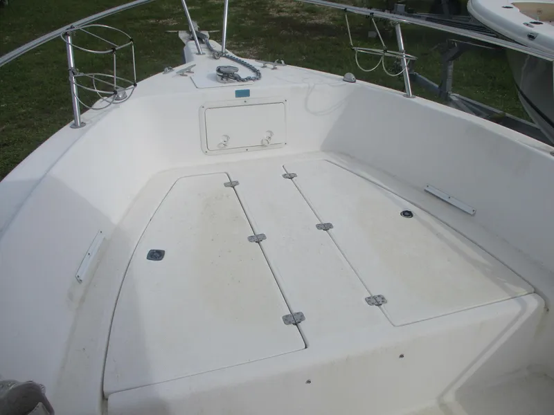 Slide: The Image of Century 2300 Center Console boat deck, 2000 model, featuring storage compartments and railing. - 6