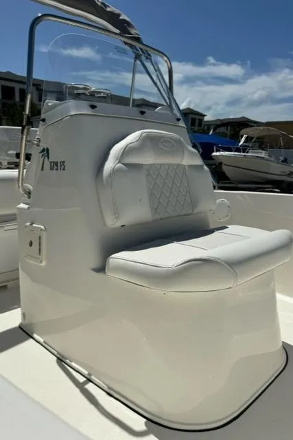 Slide: The Image of 2026 Key West 179 FS boat seat with white upholstery and console, under clear blue sky. - 10