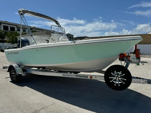 Slide: The Image of 2026 Key West 179 FS boat on trailer, light blue hull, sunny day. - 5
