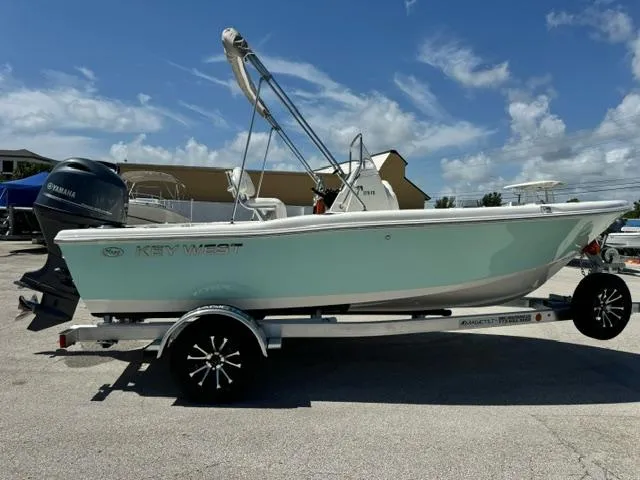 Slide: The Image of 2026 Key West 179 FS boat on trailer, featuring Yamaha outboard motor, under clear blue sky. - 6