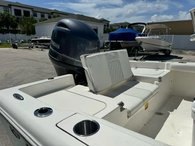 Slide: The Image of 2026 Key West 179 FS boat with Yamaha engine, parked outdoors under a clear sky. - 9