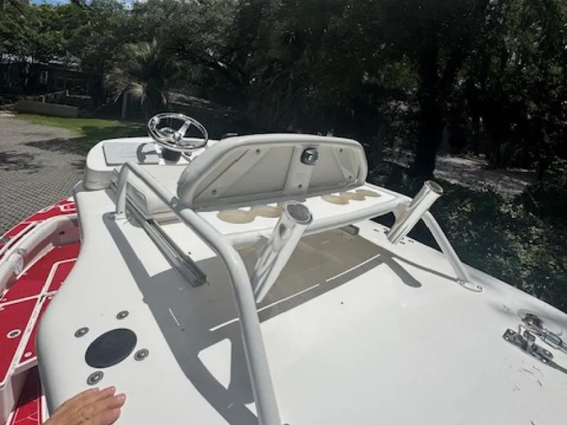Slide: The Image of 2018 Everglades 243CC boat deck with steering wheel and rod holders. - 10