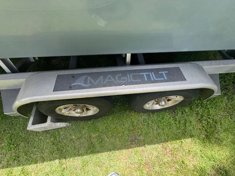 Slide: The Image of Trailer with Magic Tilt branding for 2018 Everglades 243CC boat on grass. - 12