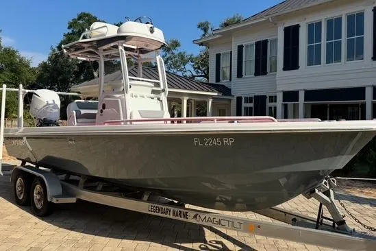 Slide: The Image of 2018 Everglades 243CC boat on trailer, parked in front of a house. - 16
