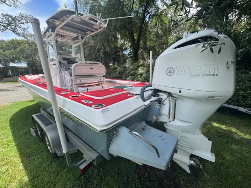 Slide: The Image of 2018 Everglades 243CC boat with Yamaha four-stroke engine, parked on grass. - 3