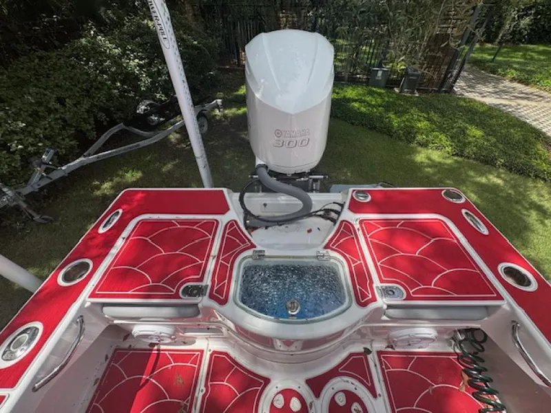 Slide: The Image of 2018 Everglades 243CC boat with red deck, Yamaha 300 engine, and livewell. - 5
