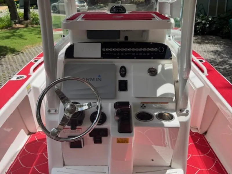 Slide: The Image of 2018 Everglades 243CC boat dashboard with steering wheel and Garmin navigation system. - 6