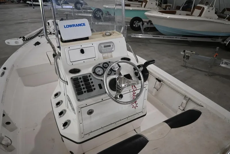 Slide: The Image of 2012 Skeeter ZX20 BAY boat interior with steering wheel and control panel in a showroom. - 11