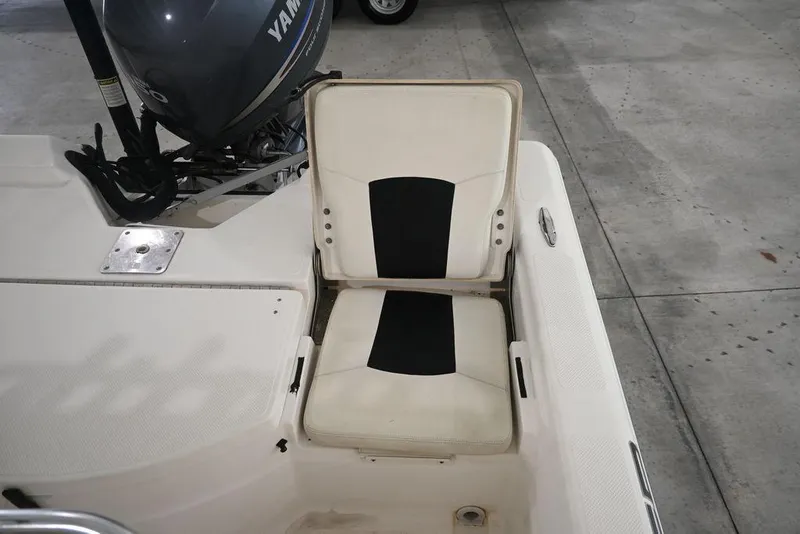 Slide: The Image of 2012 Skeeter ZX20 BAY boat seat and Yamaha motor in a garage setting. - 9