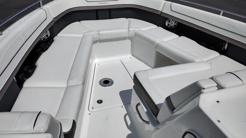 Slide: The Image of 2020 Formula 350 CBR boat interior with white seating and cup holders. - 11