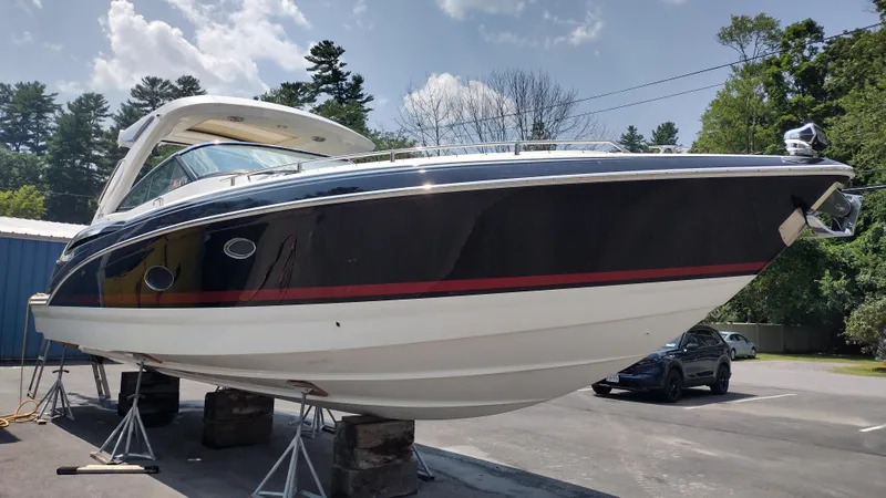 Slide: The Image of 2020 Formula 350 CBR boat on stands, outdoors under a partly cloudy sky. - 2