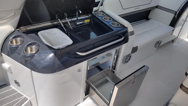 Slide: The Image of 2020 Formula 350 CBR boat interior with kitchenette and seating area. - 23