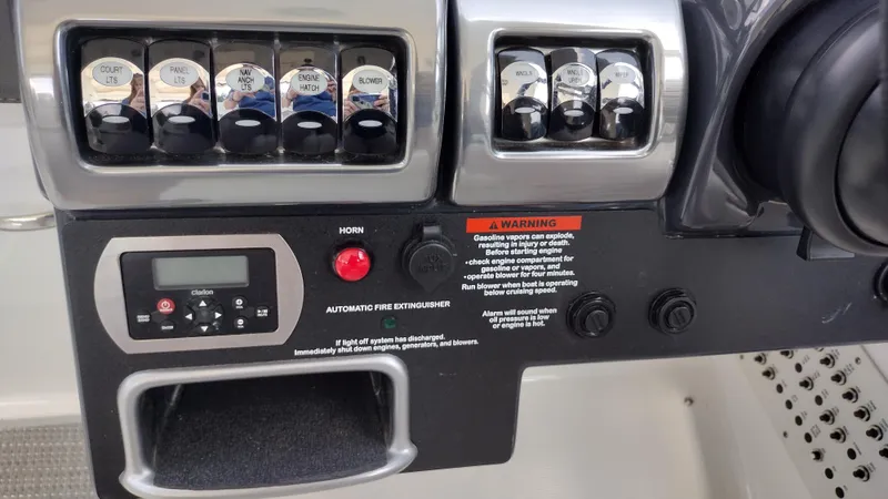 Slide: The Image of Control panel of a 2020 Formula 350 CBR boat with switches and warning labels. - 26