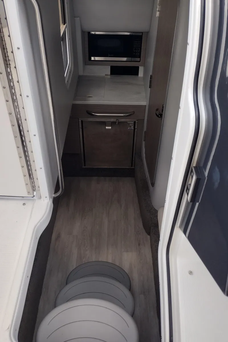 Slide: The Image of 2020 Formula 350 CBR interior with compact kitchenette and modern appliances. - 31
