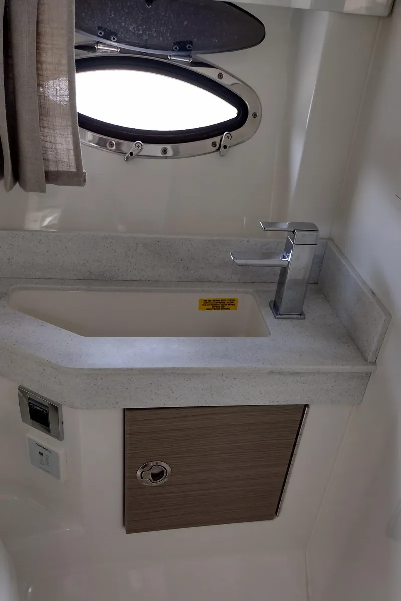 Slide: The Image of 2020 Formula 350 CBR boat bathroom sink with modern faucet and porthole window. - 35
