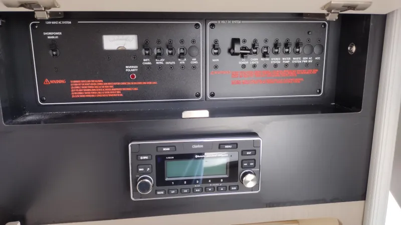 Slide: The Image of Control panel of a 2020 Formula 350 CBR boat, featuring switches and a Clarion audio system. - 40