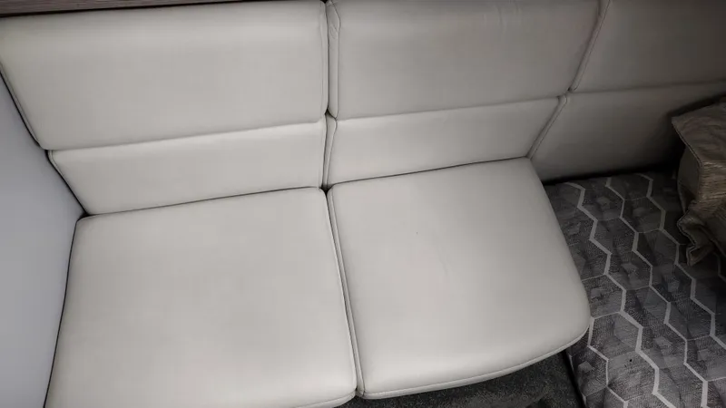 Slide: The Image of 2020 Formula 350 CBR interior seating with light upholstery and geometric-patterned flooring. - 45