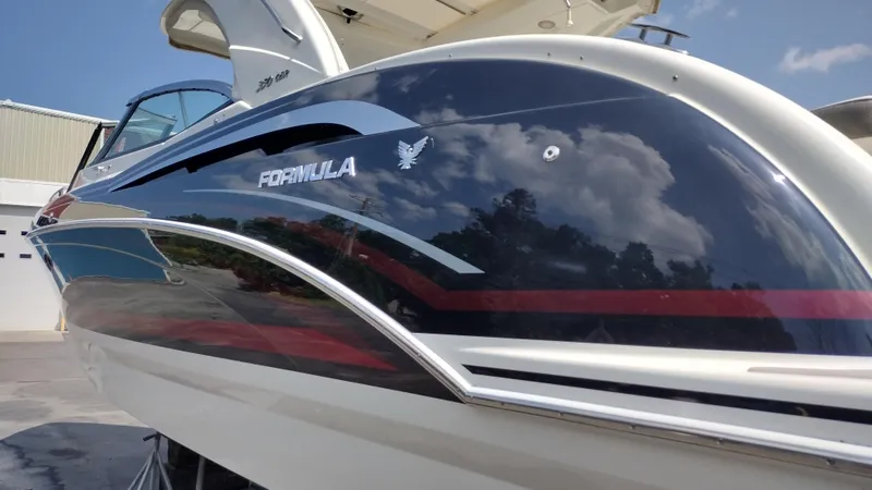 Slide: The Image of 2020 Formula 350 CBR boat with sleek design and reflective surface under blue sky. - 6