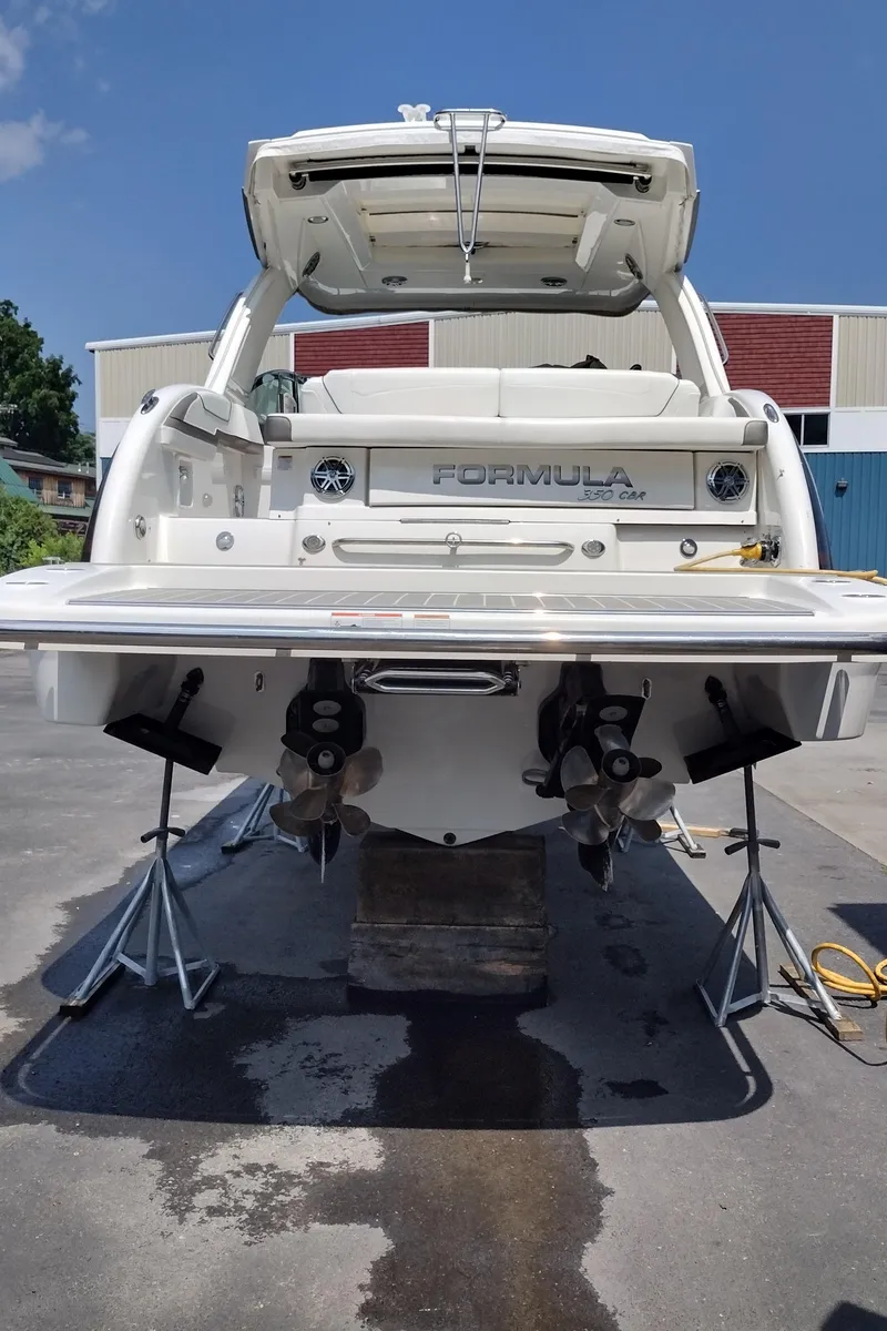 Slide: The Image of 2020 Formula 350 CBR boat on stands, rear view, outdoor setting. - 8