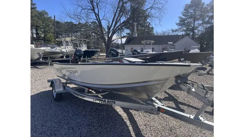 The Image of 2024 Starcraft ANGLER/PATRIOT 16TL boat on trailer in outdoor lot. - 1