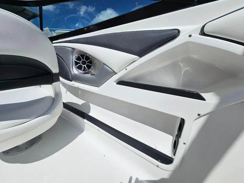 Slide: The Image of Interior of 2017 Monterey 217 Outboard boat, featuring sleek seating and speaker system. - 14