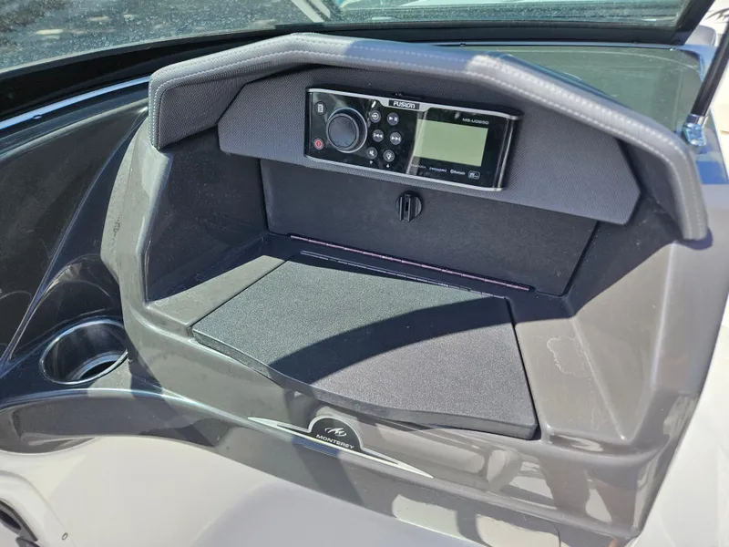 Slide: The Image of Dashboard of a 2017 Monterey 217 Outboard boat with a Fusion stereo system. - 16