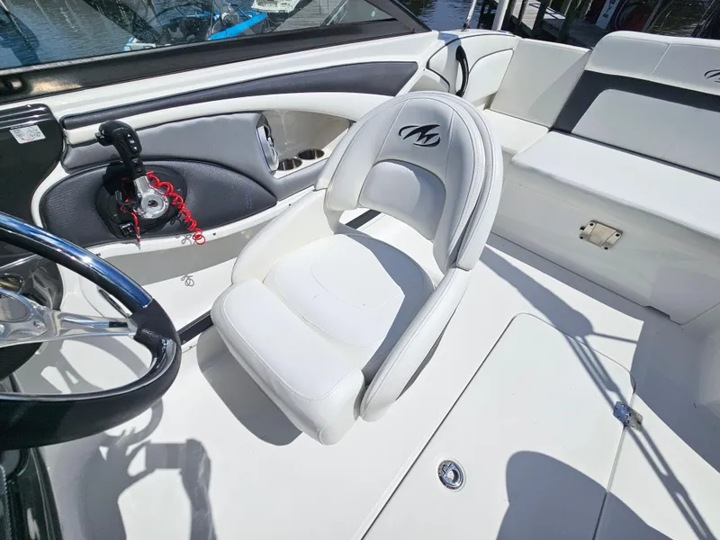 Slide: The Image of 2017 Monterey 217 Outboard boat interior with white seating and steering wheel. - 19