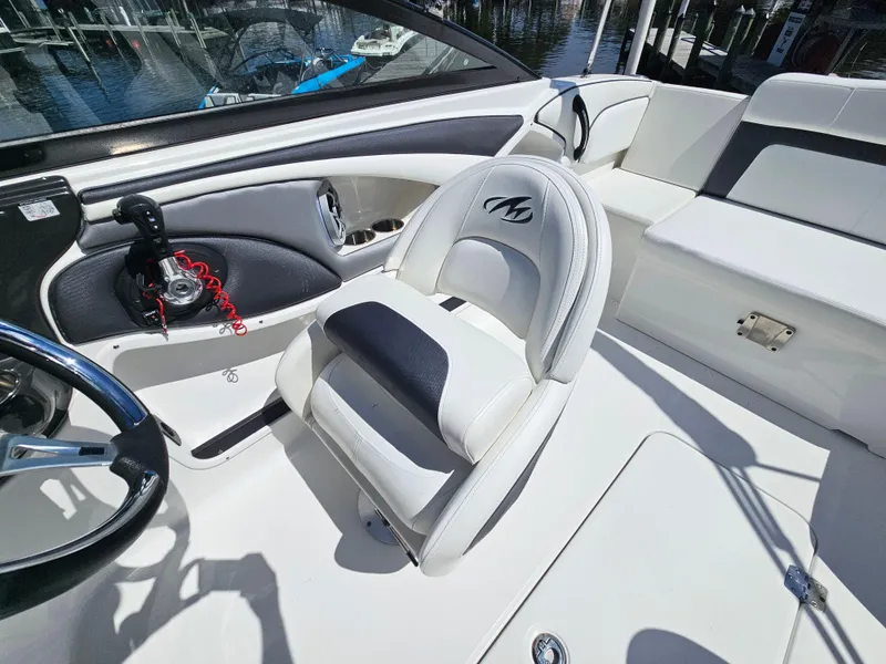 Slide: The Image of 2017 Monterey 217 Outboard boat interior with white seating and steering wheel. - 20