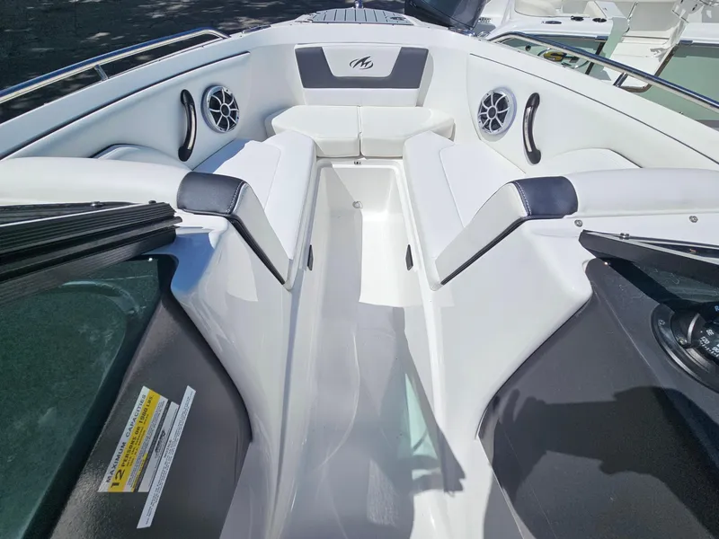 Slide: The Image of 2017 Monterey 217 Outboard boat interior with white seating and speakers. - 23