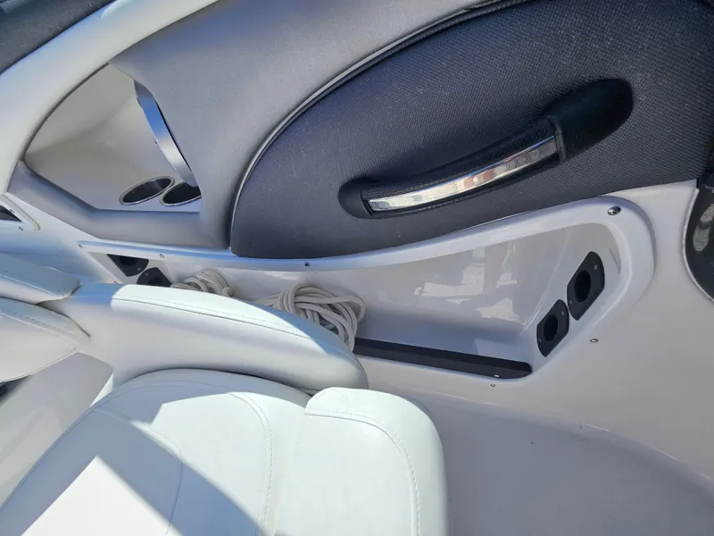 Slide: The Image of Interior of a 2017 Monterey 217 Outboard boat, featuring white seating and storage compartments. - 24