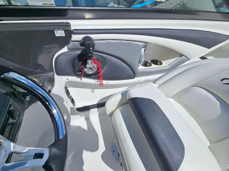 Slide: The Image of Interior of a 2017 Monterey 217 Outboard boat, featuring steering wheel and control panel. - 25