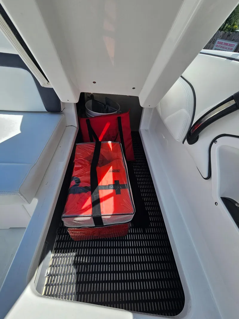 Slide: The Image of Interior of a 2017 Monterey 217 Outboard boat with red storage bags. - 33