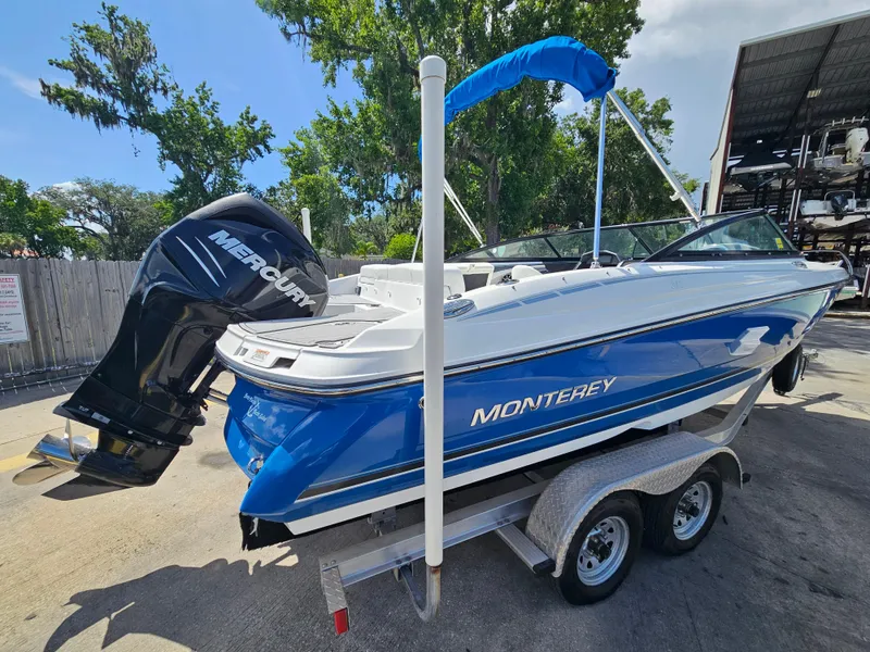 Slide: The Image of 2017 Monterey 217 Outboard boat with Mercury engine on trailer, parked outdoors. - 5