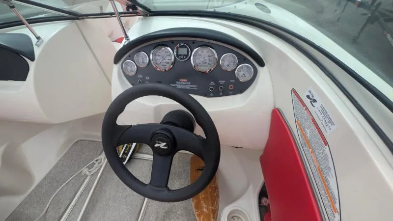 Slide: The Image of 2006 Sea Ray 185 Sport boat dashboard with steering wheel and instrument panel. - 3