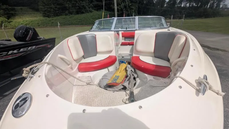 Slide: The Image of 2006 Sea Ray 185 Sport boat with red and white seating, docked outdoors. - 9