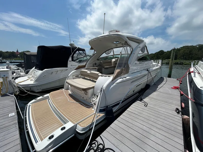 The Image of 2021 Formula 34 Performance Cruiser docked at marina under blue sky. - 0