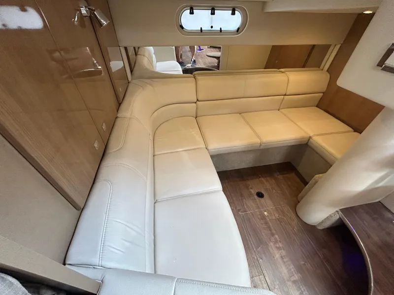 Slide: The Image of Interior of 2021 Formula 34 Performance Cruiser with beige leather seating and wood flooring. - 17