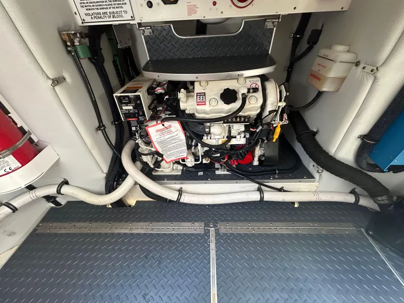 Slide: The Image of Engine compartment of a 2021 Formula 34 Performance Cruiser, showcasing mechanical components and wiring. - 20