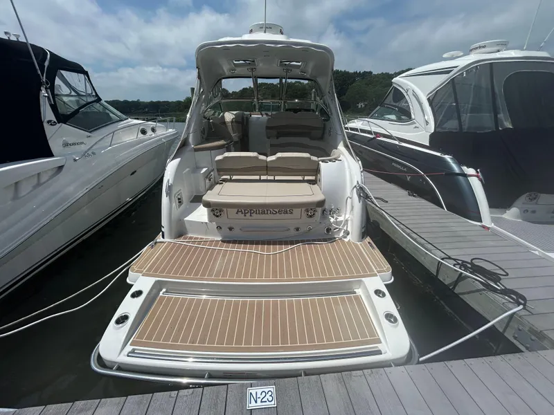 Slide: The Image of 2021 Formula 34 Performance Cruiser docked, showcasing spacious deck and seating area. - 3