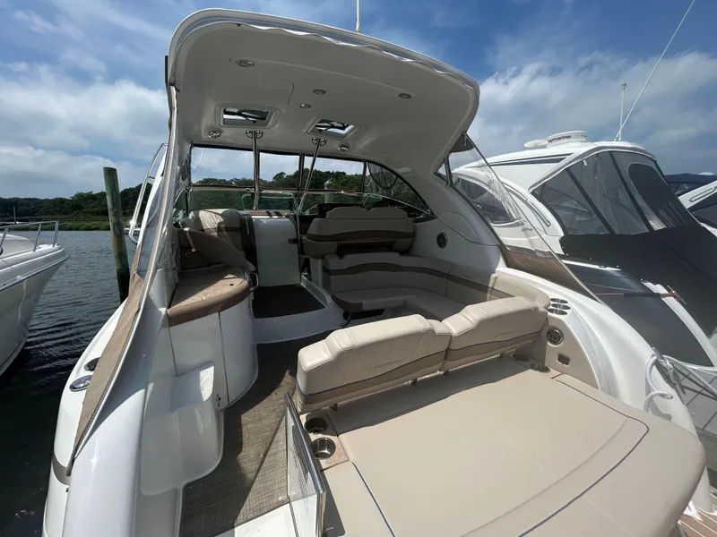 Slide: The Image of 2021 Formula 34 Performance Cruiser with spacious seating and sleek design, docked by the water. - 4