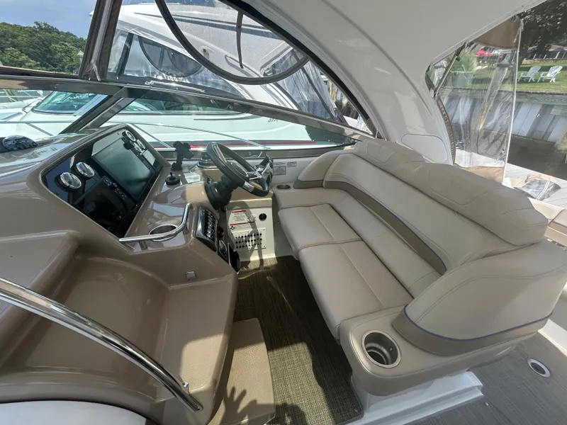Slide: The Image of 2021 Formula 34 Performance Cruiser interior with beige seating and modern dashboard. - 7