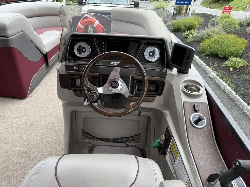 Slide: The Image of Steering console of a 2015 Premier 250 Solaris pontoon boat with gauges and controls. - 14