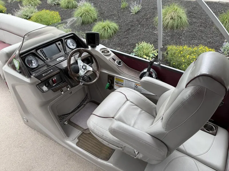 Slide: The Image of Premier 250 Solaris 2015 boat cockpit with steering wheel and control panel. - 15